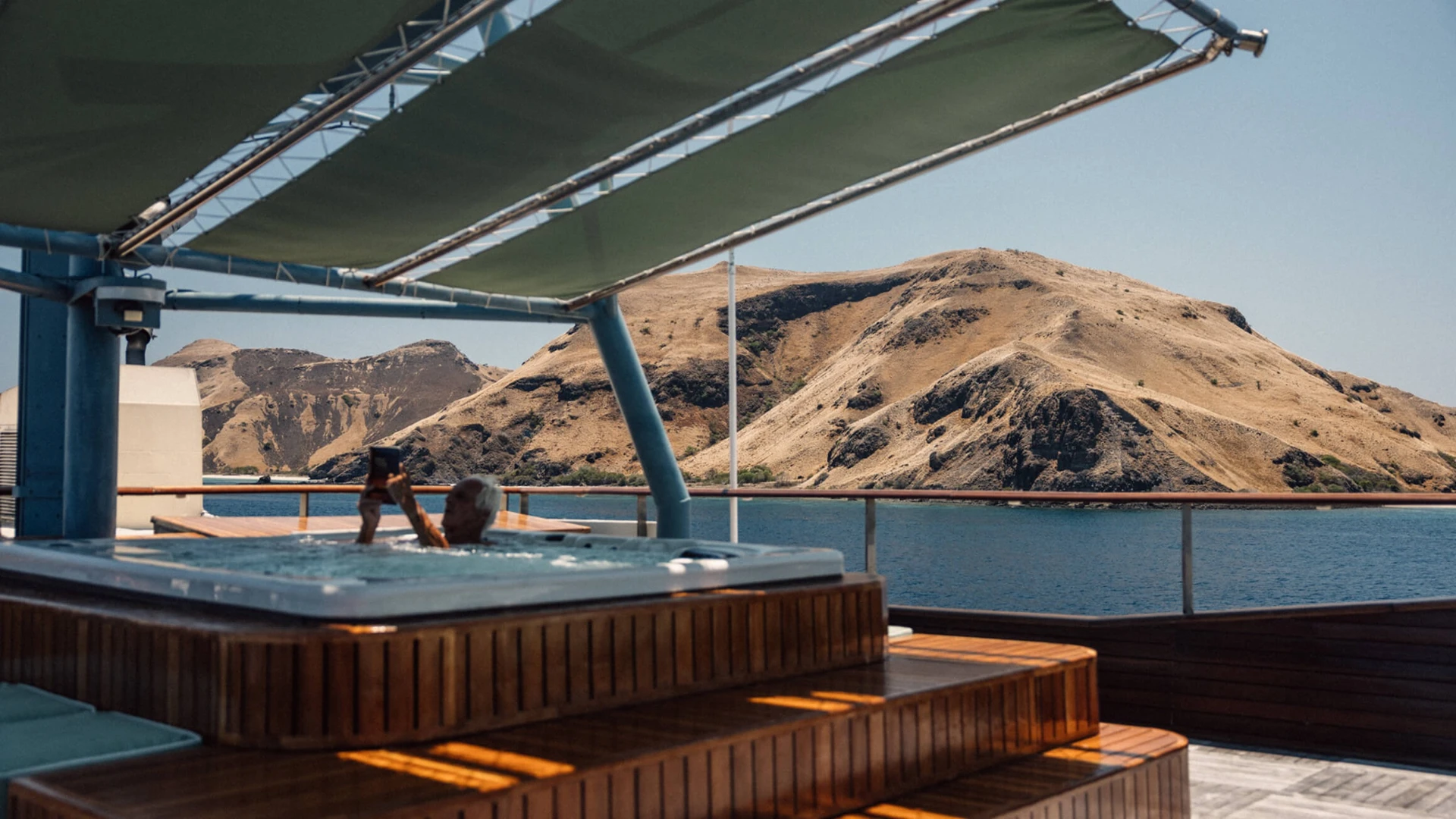 Rooftop jacuzzi on Kudanil Explorer with view over Komodo hills